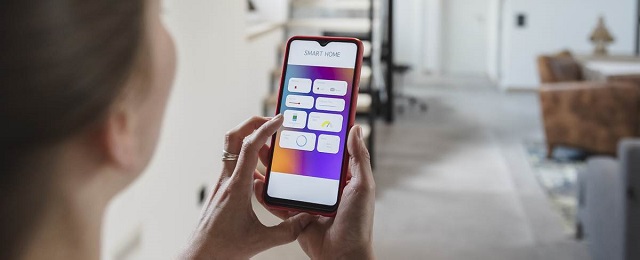 Man using smartphone at smart home